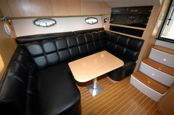 Slide: The Image of 2002 Tiara Yachts 3500 Open interior with black leather seating. - 12