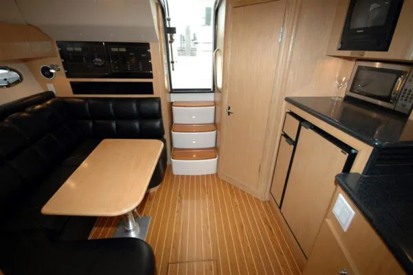 Slide: The Image of 2002 Tiara Yachts 3500 Open interior with kitchen and seating area. - 13