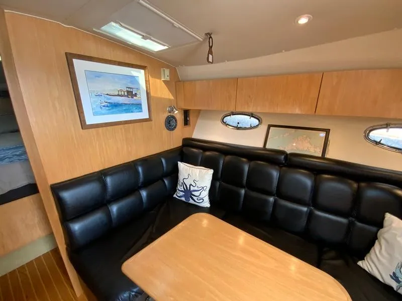 Slide: The Image of Interior of a 2002 Tiara Yachts 3500 Open with leather seating. - 15