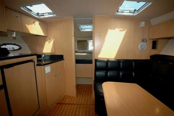 Slide: The Image of Interior of 2002 Tiara Yachts 3500 Open with wooden furnishings. - 9