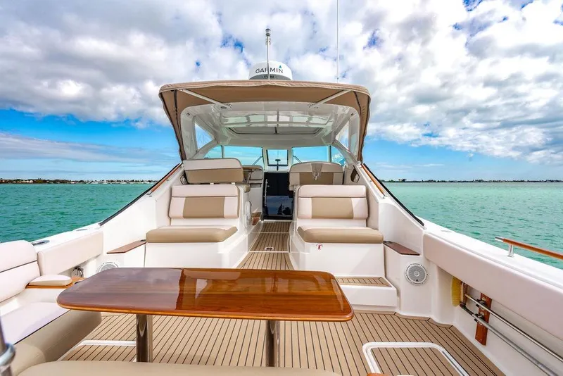 Slide: The Image of 2013 Tiara Yachts 3600 Coronet on serene water, featuring spacious seating and elegant design. - 1