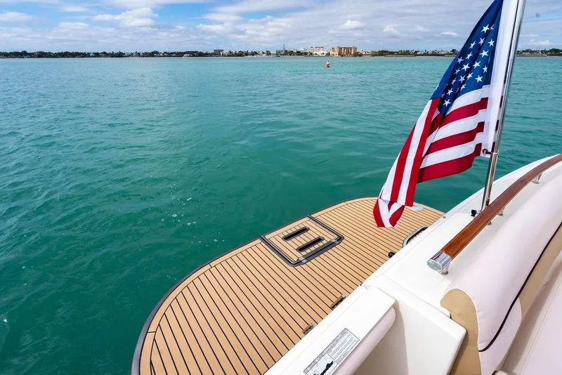 Slide: The Image of Tiara Yachts 3600 Coronet 2013 with American flag on turquoise water. - 10