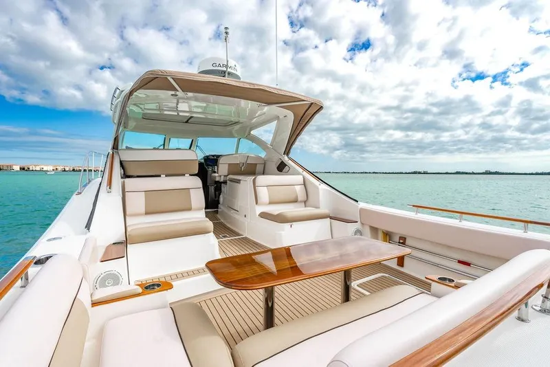 Slide: The Image of 2013 Tiara Yachts 3600 Coronet on serene water, featuring luxurious seating and sleek design. - 11