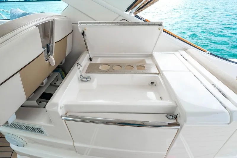 Slide: The Image of 2013 Tiara Yachts 3600 Coronet interior with sink and seating, overlooking ocean. - 18