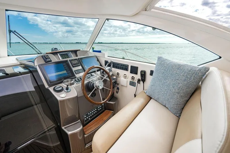 Slide: The Image of 2013 Tiara Yachts 3600 Coronet helm with modern controls and ocean view. - 21