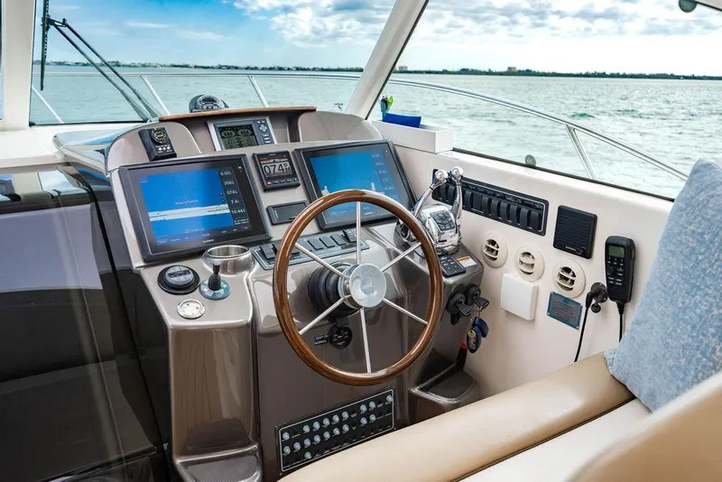 Slide: The Image of Cockpit of 2013 Tiara Yachts 3600 Coronet with modern navigation equipment and steering wheel. - 3