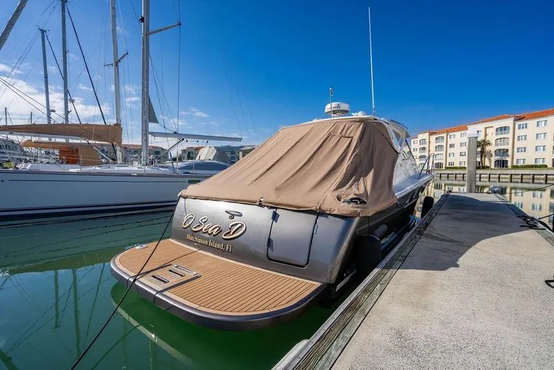 Slide: The Image of 2013 Tiara Yachts 3600 Coronet docked, covered, with clear blue sky background. - 38