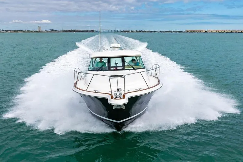Slide: The Image of 2013 Tiara Yachts 3600 Coronet cruising on open water, creating a dynamic wake. - 39