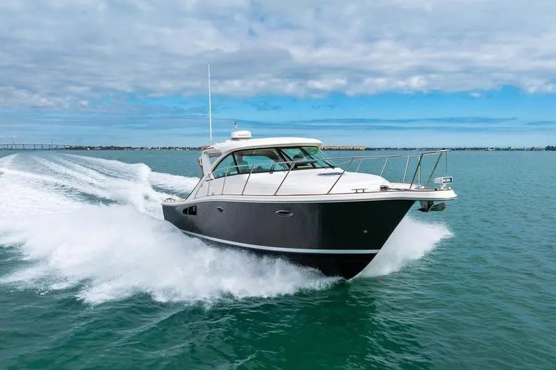 Slide: The Image of 2013 Tiara Yachts 3600 Coronet cruising on open water under a cloudy sky. - 40