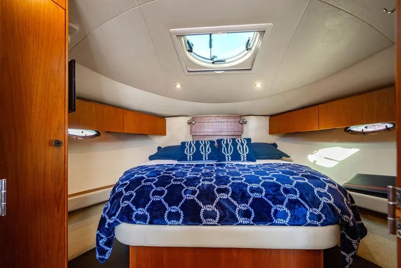 Slide: The Image of Luxurious cabin interior of 2013 Tiara Yachts 3600 Coronet with cozy bedding and wood accents. - 7