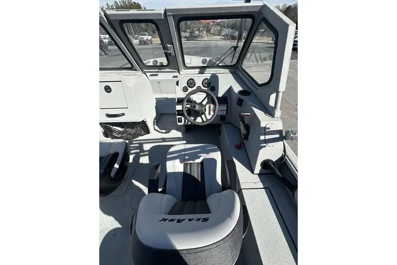 Slide: The Image of 2025 SeaArk ProCat 240 boat interior with steering wheel and seating. - 10