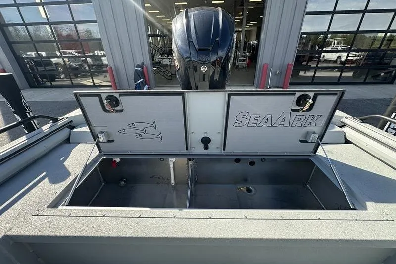 Slide: The Image of 2025 SeaArk ProCat 240 boat with open storage compartments and visible motor. - 2