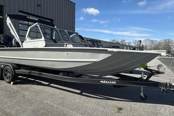 Slide: The Image of 2025 SeaArk ProCat 240 boat on trailer, parked outdoors under blue sky. - 3