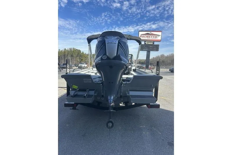Slide: The Image of 2025 SeaArk ProCat 240 boat rear view with outboard motor under clear sky. - 4