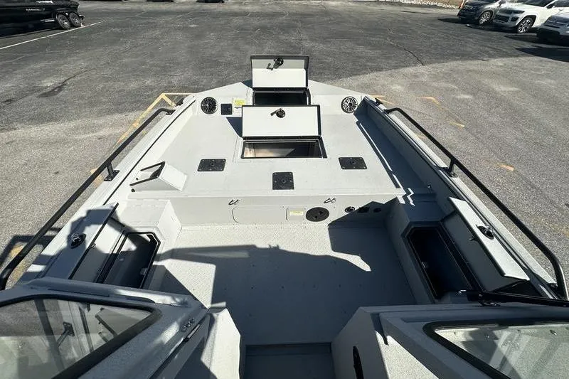 Slide: The Image of 2025 SeaArk ProCat 240 boat interior with open storage compartments and seating area. - 9