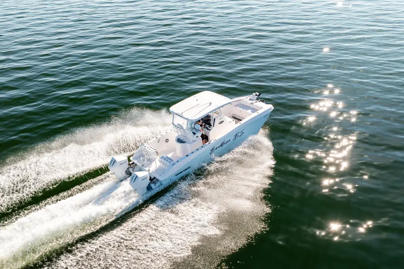 Slide: The Image of 2023 Twin Vee 260 GFX CC boat cruising on open water, creating a wake. - 11