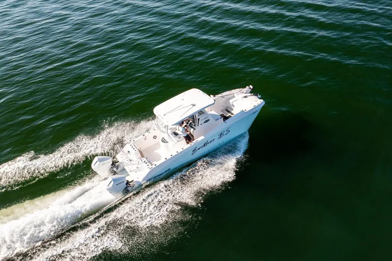 Slide: The Image of 2023 Twin Vee 260 GFX CC boat cruising on open water, aerial view. - 16