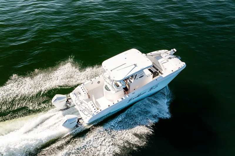 Slide: The Image of 2023 Twin Vee 260 GFX CC boat cruising on open water, aerial view. - 17