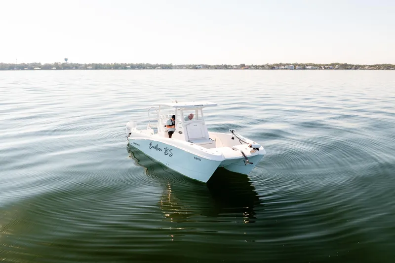 Slide: The Image of 2023 Twin Vee 260 GFX CC boat cruising on calm waters. - 2