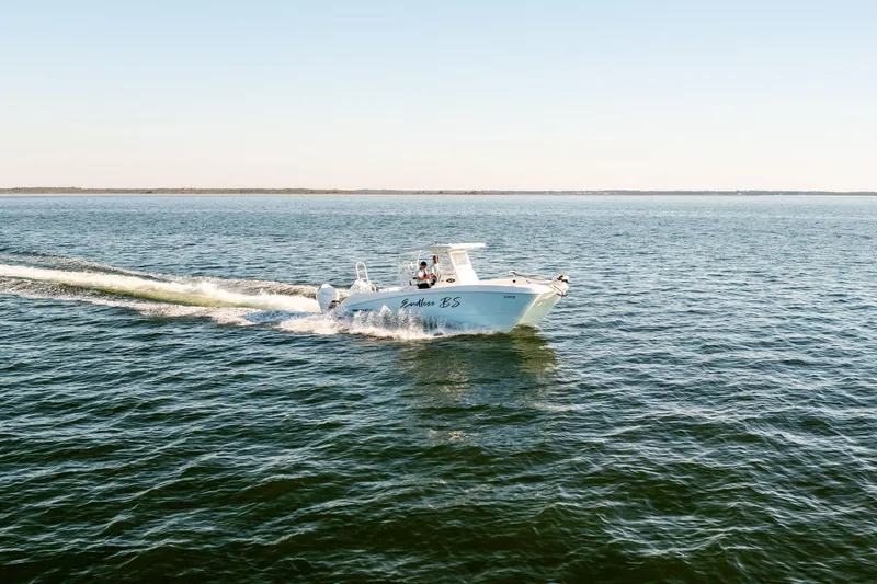 Slide: The Image of 2023 Twin Vee 260 GFX CC cruising on open water under clear skies. - 20