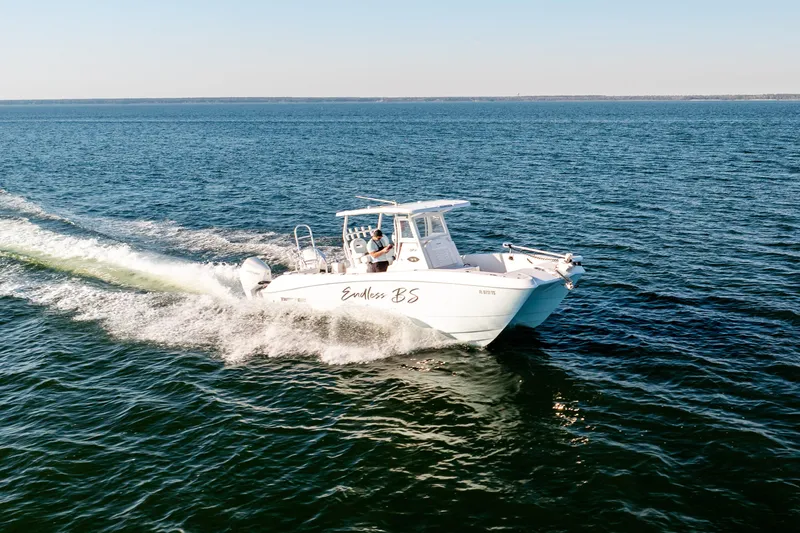 Slide: The Image of 2023 Twin Vee 260 GFX CC cruising on open water, showcasing sleek design and performance. - 22