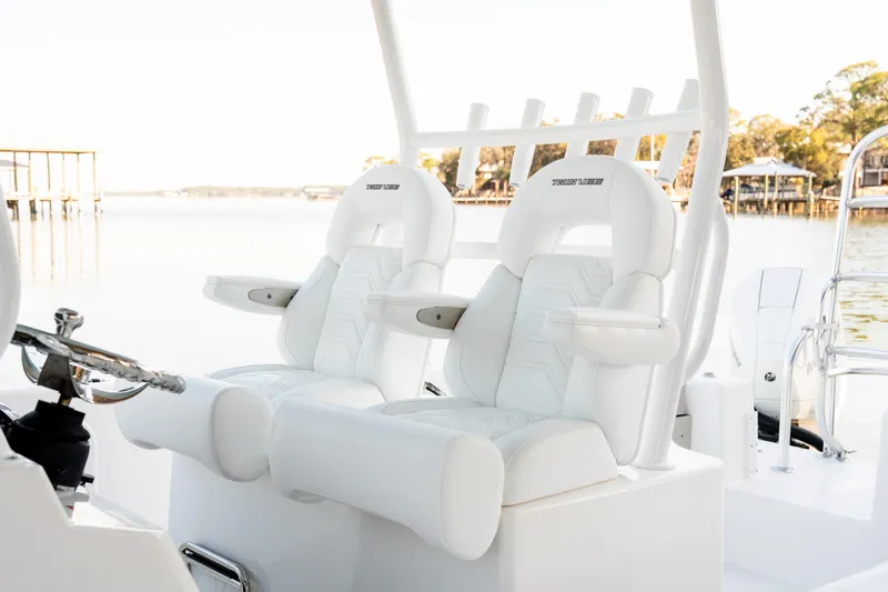 Slide: The Image of 2023 Twin Vee 260 GFX CC boat interior with luxurious white seating by the water. - 27