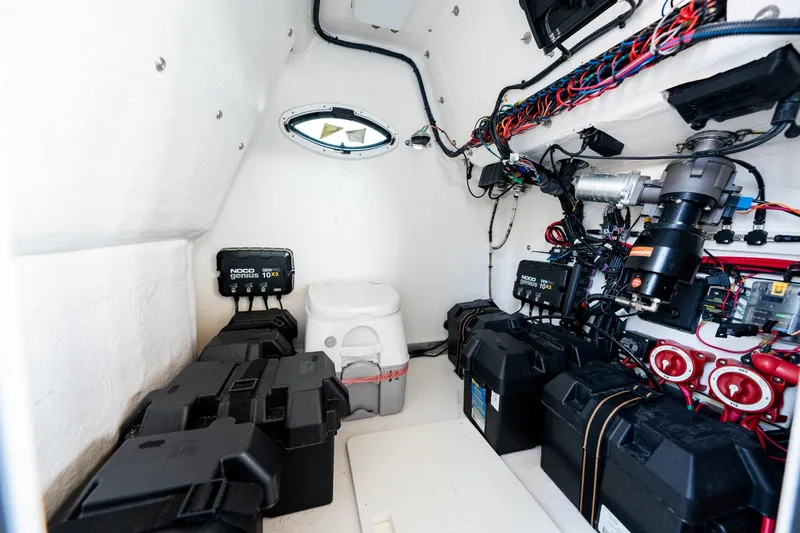 Slide: The Image of 2023 Twin Vee 260 GFX CC boat interior with electrical components and wiring. - 29