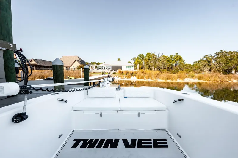 Slide: The Image of 2023 Twin Vee 260 GFX CC boat docked by a serene waterfront home. - 34