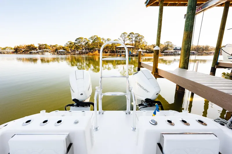 Slide: The Image of 2023 Twin Vee 260 GFX CC boat docked on calm water with dual Mercury engines. - 41