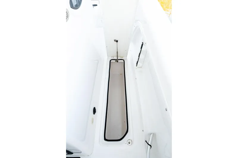 Slide: The Image of 2023 Twin Vee 260 GFX CC boat interior storage compartment, white and spacious design. - 44