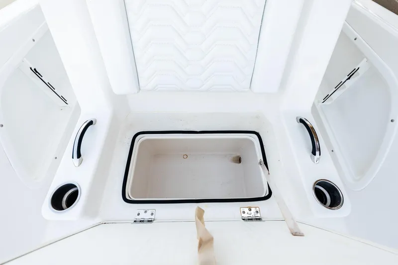 Slide: The Image of 2023 Twin Vee 260 GFX CC boat interior with storage compartment and cup holders. - 45