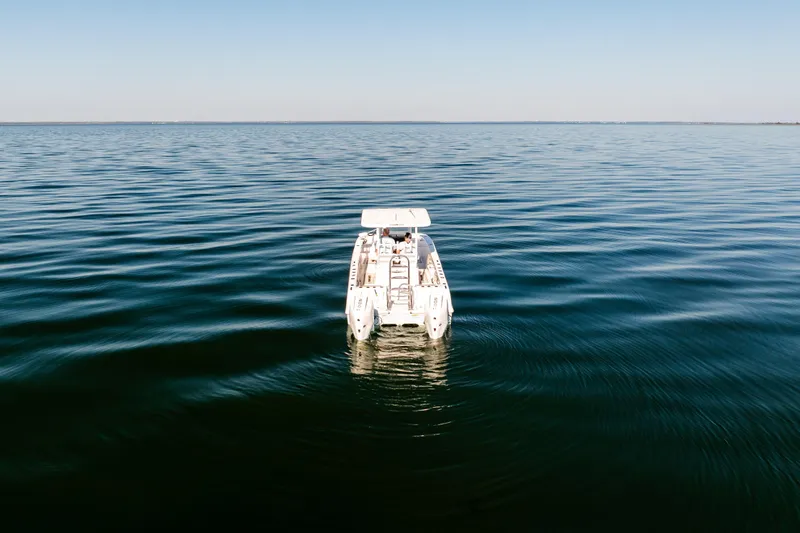 Slide: The Image of 2023 Twin Vee 260 GFX CC boat on calm open water, aerial view. - 5