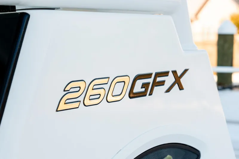 Slide: The Image of 2023 Twin Vee 260 GFX CC boat logo on white surface. - 51