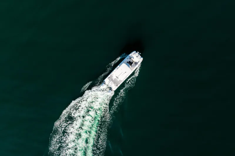 Slide: The Image of Aerial view of 2023 Twin Vee 260 GFX CC boat cruising on open water. - 6