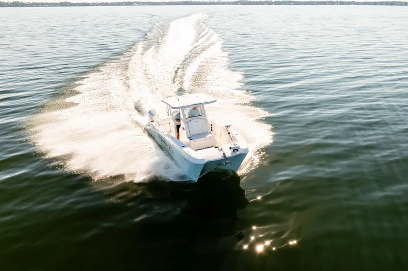 Slide: The Image of 2023 Twin Vee 260 GFX CC cruising on open water, creating a dynamic wake. - 9