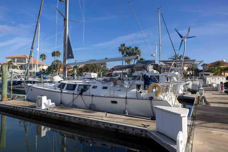 The Image of 2001 Jeanneau Sun Odyssey 43 DS sailboat docked at marina under clear blue sky. - 0