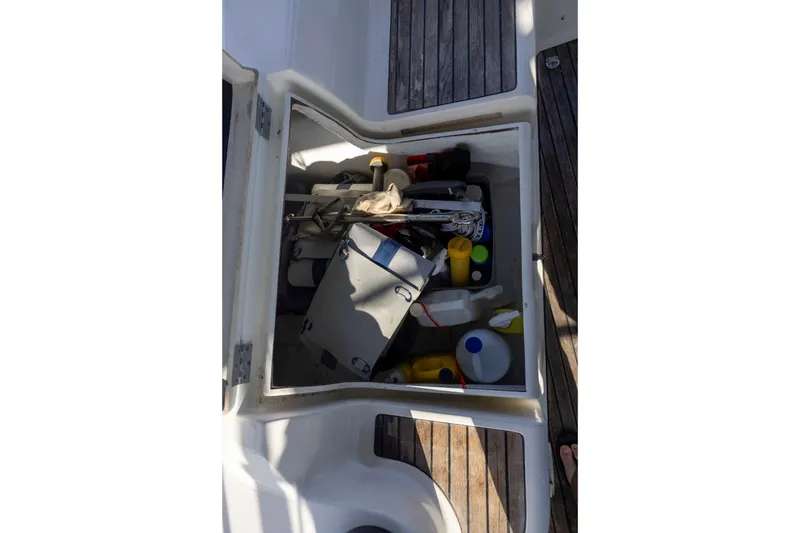 Slide: The Image of Storage compartment on 2001 Jeanneau Sun Odyssey 43 DS sailboat, filled with various boating supplies. - 15