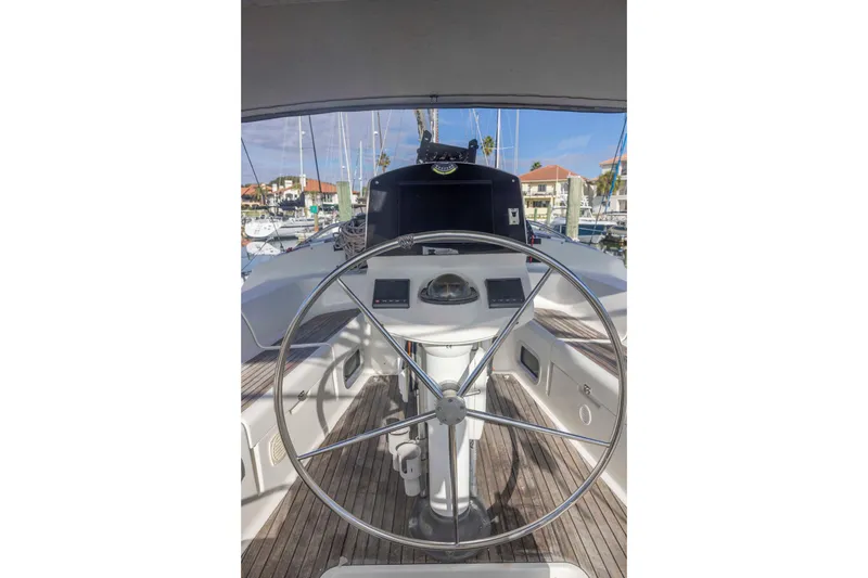 Slide: The Image of Steering wheel of 2001 Jeanneau Sun Odyssey 43 DS sailboat in marina setting. - 19