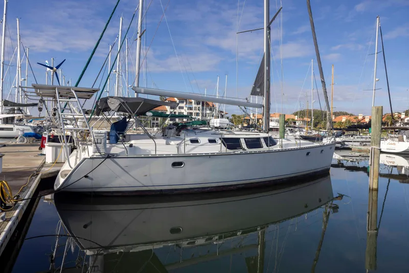 Slide: The Image of 2001 Jeanneau Sun Odyssey 43 DS sailboat docked in a marina under clear skies. - 2