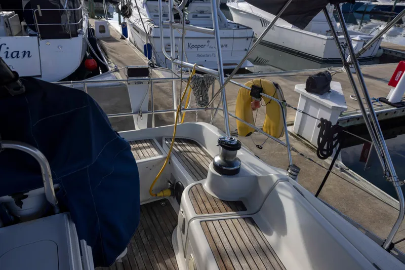 Slide: The Image of Jeanneau Sun Odyssey 43 DS sailboat docked, showcasing deck and marina view, 2001 model. - 21