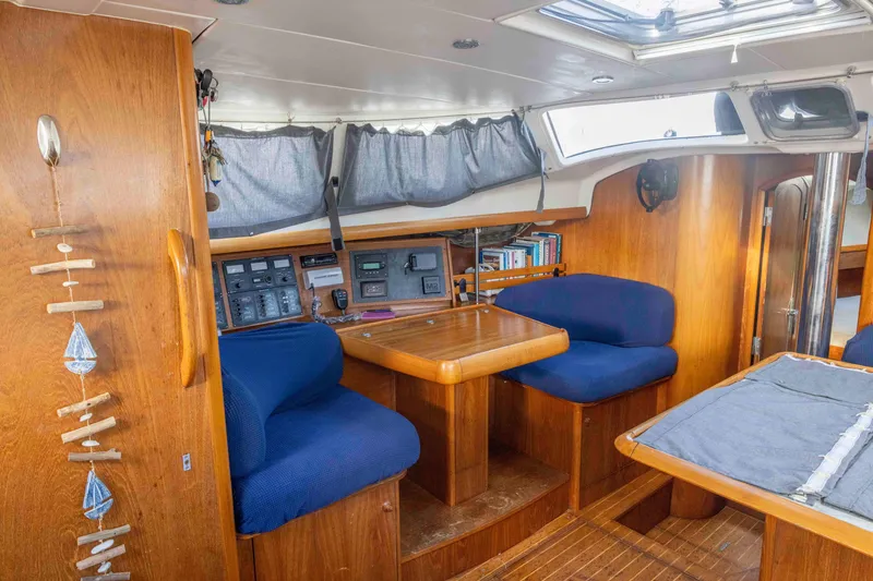 Slide: The Image of Interior of 2001 Jeanneau Sun Odyssey 43 DS sailboat with wooden furnishings and blue seating. - 25