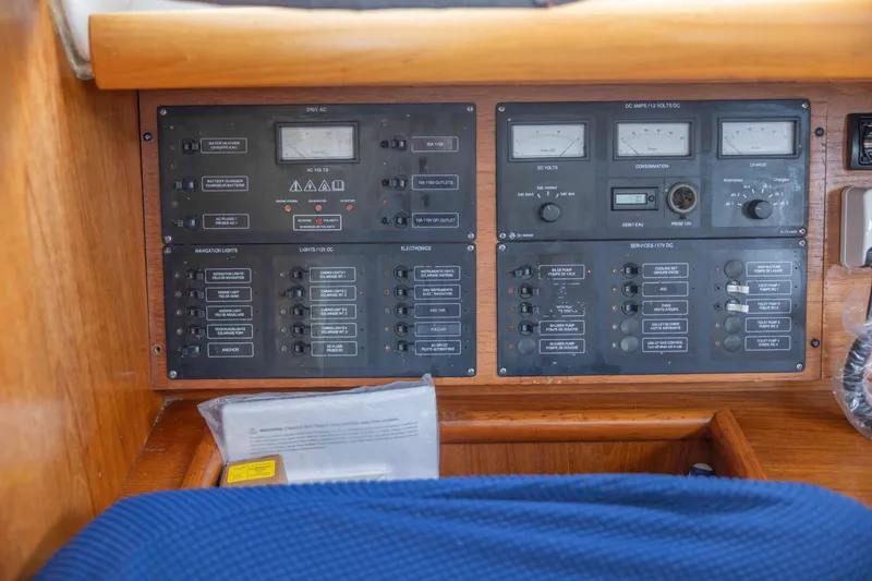 Slide: The Image of Control panel of a 2001 Jeanneau Sun Odyssey 43 DS sailboat, featuring various switches and gauges. - 27