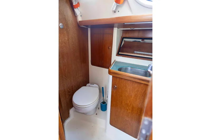 Slide: The Image of 2001 Jeanneau Sun Odyssey 43 DS yacht bathroom with wooden cabinetry and compact sink. - 34