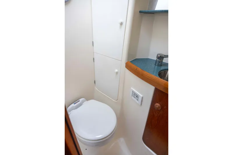 Slide: The Image of Bathroom interior of 2001 Jeanneau Sun Odyssey 43 DS yacht, featuring toilet and sink. - 36