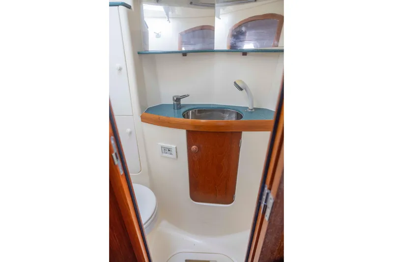 Slide: The Image of Bathroom interior of 2001 Jeanneau Sun Odyssey 43 DS yacht, featuring sink and wooden cabinetry. - 37