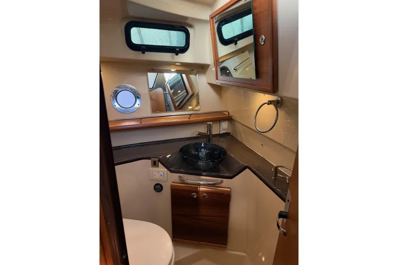 Slide: The Image of Luxurious 2024 Ranger Tugs R-29 CB bathroom with modern fixtures and elegant wood accents. - 17