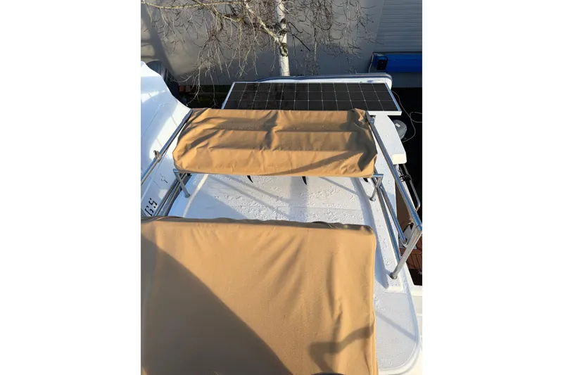 Slide: The Image of 2024 Ranger Tugs R-29 CB boat with solar panel and tan covers on deck. - 5