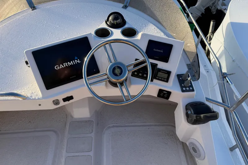 Slide: The Image of 2024 Ranger Tugs R-29 CB helm with Garmin navigation system and steering wheel. - 6
