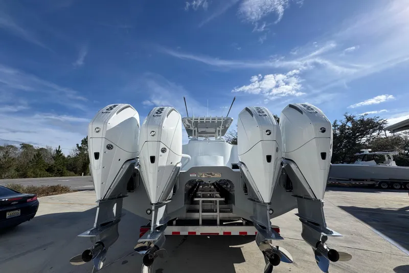 Slide: The Image of 2026 Invincible 36 Catamaran with four powerful outboard engines under a clear blue sky. - 15