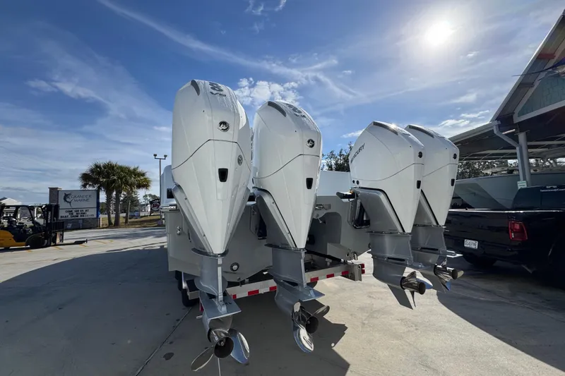 Slide: The Image of 2026 Invincible 36 Catamaran with four powerful outboard motors in a sunny marina setting. - 16